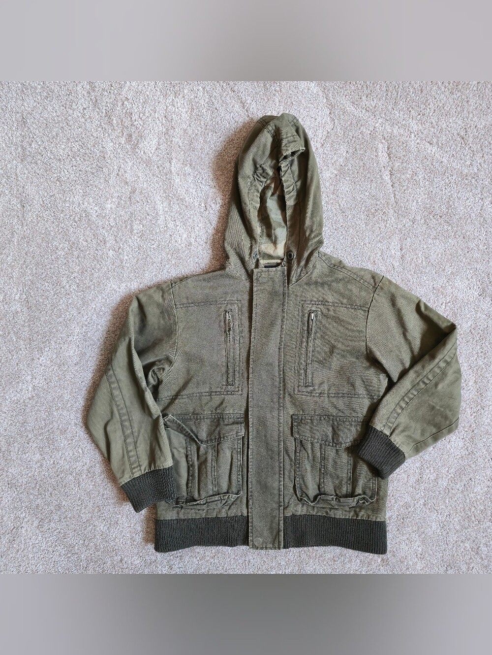 Olive green canvas utility/military jacket with a hood and ribbed cuffs